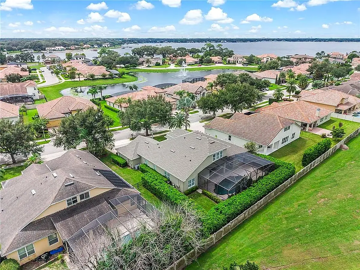 Aerial view of a lakeside neighborhood with tile and shingle roofs, Lake Nona roofing service area