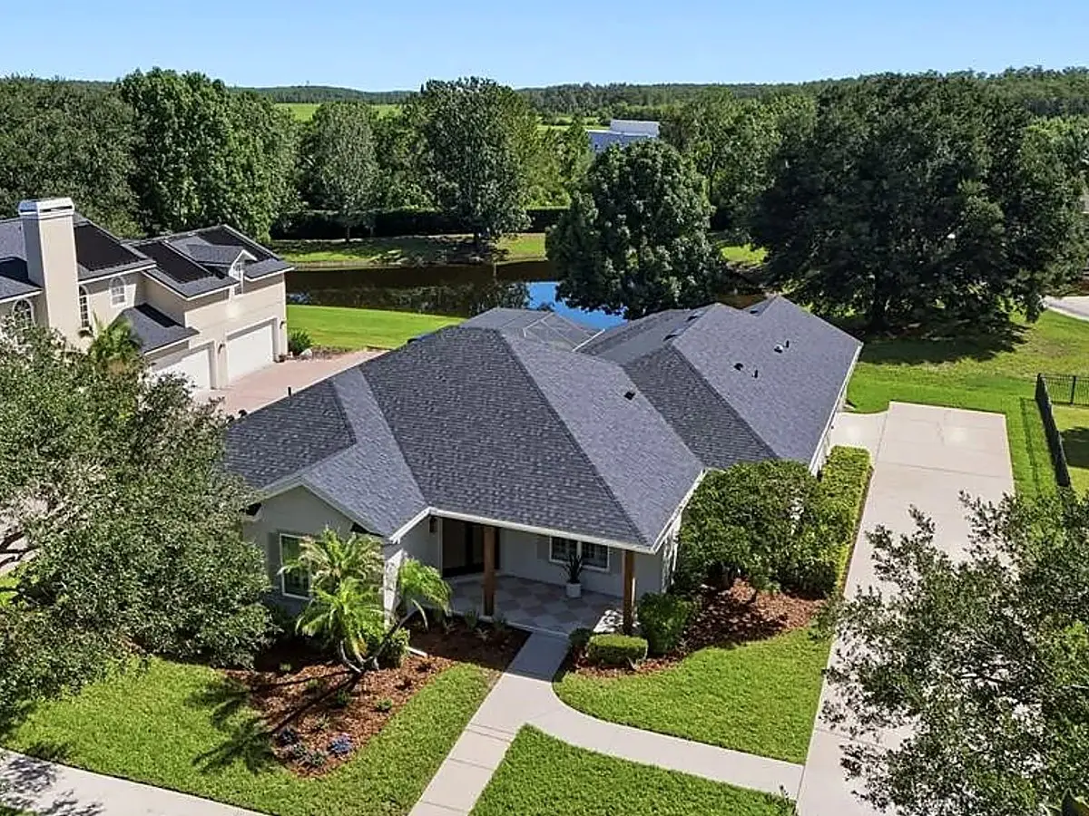 Aerial view of a finished charcoal shingle roof on a single-story home at close-out